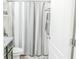 Hall bathroom with a gray and white patterned shower curtain, gray vanity, and a gray bath mat at 6144 Forest Ridge Way, Winter Haven, FL 33881
