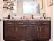 Modern bathroom featuring double vessel sinks atop a dark cabinet and granite countertop at 6144 Forest Ridge Way, Winter Haven, FL 33881