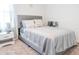 Comfortable bedroom with a gray upholstered bed, soft pillows, and neutral decor for a serene retreat at 6144 Forest Ridge Way, Winter Haven, FL 33881
