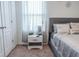 Stylish bedroom with a gray bed, patterned curtains, and a modern nightstand, offering a comfortable and chic space at 6144 Forest Ridge Way, Winter Haven, FL 33881