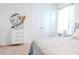 Bright bedroom with a white dresser and soft, neutral tones creating a calm and inviting atmosphere at 6144 Forest Ridge Way, Winter Haven, FL 33881