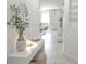 Bright entryway featuring tile flooring, white walls, decorative console table, and a view into the living area at 6144 Forest Ridge Way, Winter Haven, FL 33881