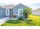 Charming home exterior with mature landscaping and a well-manicured lawn at 6144 Forest Ridge Way, Winter Haven, FL 33881