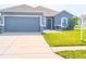 Charming one-story home with a well-manicured lawn, two car garage, and neutral blue paint at 6144 Forest Ridge Way, Winter Haven, FL 33881