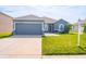 Charming one-story home with a well-manicured lawn, two car garage, and neutral blue paint at 6144 Forest Ridge Way, Winter Haven, FL 33881