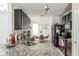 Kitchen featuring granite countertops, stainless steel sink, dark cabinets, and an adjacent dining area at 6144 Forest Ridge Way, Winter Haven, FL 33881