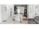 Bright kitchen featuring granite island, stainless steel sink, dark cabinets, and an open floor plan at 6144 Forest Ridge Way, Winter Haven, FL 33881