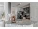 Kitchen featuring a granite island with a stainless steel sink and dark cabinets at 6144 Forest Ridge Way, Winter Haven, FL 33881