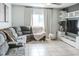 Comfortable living room features large sectional sofa, tiled floors, and decorative shelving at 6144 Forest Ridge Way, Winter Haven, FL 33881