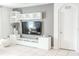 Living room features a modern media console and a gray accent wall at 6144 Forest Ridge Way, Winter Haven, FL 33881