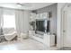 Living room with a cozy gray sectional sofa, tile floors, and modern media console at 6144 Forest Ridge Way, Winter Haven, FL 33881