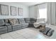 Comfortable living room with a large gray sectional sofa and tile floors at 6144 Forest Ridge Way, Winter Haven, FL 33881