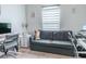 Cozy home office with a gray futon couch, a modern desk, and soft, natural lighting at 6144 Forest Ridge Way, Winter Haven, FL 33881