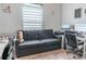 Home office featuring a gray futon couch, a modern desk, and soft, natural lighting at 6144 Forest Ridge Way, Winter Haven, FL 33881
