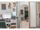 Home office featuring a workspace with monitors and a view into the kitchen and dining area at 6144 Forest Ridge Way, Winter Haven, FL 33881