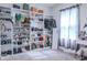Organized walk-in closet with extensive shelving and storage, showcasing a variety of shoes, handbags, and clothing at 6144 Forest Ridge Way, Winter Haven, FL 33881