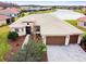 Single-story home with tile roof, two-car garage, and lake view at 644 San Raphael St, Kissimmee, FL 34759