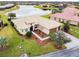 Aerial view of a house with a landscaped yard and driveway at 644 San Raphael St, Kissimmee, FL 34759