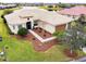 Aerial view of a house with a landscaped yard and driveway at 644 San Raphael St, Kissimmee, FL 34759