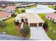 Aerial view of a house with a landscaped yard and driveway at 644 San Raphael St, Kissimmee, FL 34759