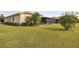 Landscaped backyard with home and screened patio view at 644 San Raphael St, Kissimmee, FL 34759