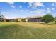 Spacious backyard with grassy lawn, screened enclosure, and mature trees at 644 San Raphael St, Kissimmee, FL 34759