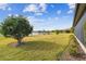 Landscaped backyard with lake view and lush green grass at 644 San Raphael St, Kissimmee, FL 34759