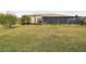 Landscaped backyard with home and screened patio view at 644 San Raphael St, Kissimmee, FL 34759
