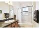 Modern bathroom with a tub, shower, and dark vanity at 644 San Raphael St, Kissimmee, FL 34759