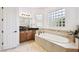 Bathroom with corner vanity, soaking tub, and large windows at 644 San Raphael St, Kissimmee, FL 34759