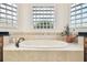 Bathroom featuring a freestanding soaking tub and neutral tile at 644 San Raphael St, Kissimmee, FL 34759