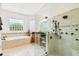 Spa-like bathroom with a large walk-in shower and soaking tub at 644 San Raphael St, Kissimmee, FL 34759
