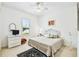 Bright bedroom with a king-size bed, white dresser, and window with shutters at 644 San Raphael St, Kissimmee, FL 34759