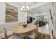 Bright dining room features a wood table with seating for six and a view into the living room at 644 San Raphael St, Kissimmee, FL 34759