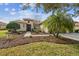 Landscaped front yard with a brick walkway and lush vegetation at 644 San Raphael St, Kissimmee, FL 34759