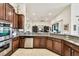 Kitchen boasts dark wood cabinets, granite countertops, and stainless steel appliances at 644 San Raphael St, Kissimmee, FL 34759