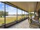 Relaxing screened lanai with lake view and comfortable seating at 644 San Raphael St, Kissimmee, FL 34759