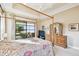 Main bedroom with a king-size bed, dresser, and access to private patio at 644 San Raphael St, Kissimmee, FL 34759