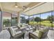 Relaxing screened patio furnished with wicker seating and a coffee table at 644 San Raphael St, Kissimmee, FL 34759