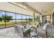 Spacious screened patio overlooking a lake with wicker furniture at 644 San Raphael St, Kissimmee, FL 34759