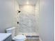 Clean bathroom with marble shower and white toilet at 645 King St, Eustis, FL 32726