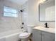 Modern bathroom with marble tile, vanity, and bathtub at 645 King St, Eustis, FL 32726