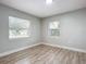 Spacious bedroom with two windows and wood-look floors at 645 King St, Eustis, FL 32726