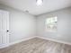 Bedroom with wood-look floors, window, and closet at 645 King St, Eustis, FL 32726