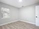 Well-lit bedroom featuring wood-look floors and a window at 645 King St, Eustis, FL 32726