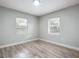 Bright bedroom with two windows and wood-look floors at 645 King St, Eustis, FL 32726