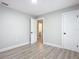Bedroom with wood-look floors and access to another room and bathroom at 645 King St, Eustis, FL 32726