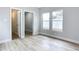 Bright bedroom with wood-look floors, en-suite bathroom access, and large windows at 645 King St, Eustis, FL 32726