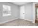 Bedroom with wood-look floors, window, and closet at 645 King St, Eustis, FL 32726