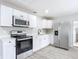 Modern kitchen with white cabinets and stainless steel appliances at 645 King St, Eustis, FL 32726
